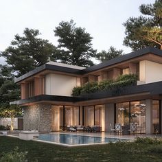 a house with a pool in front of it and trees on the other side of the building