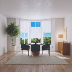 a living room filled with furniture and a round table in front of two windows covered in blinds