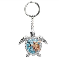 a keychain with a turtle on it's back and an ocean theme