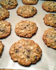 chocolate chip oatmeal cookies sitting on top of a baking sheet in an oven