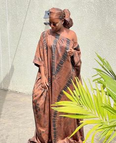 🎈This Nigerian Bubu Dress is made of high-quality adire silk (Nigerian tie-dye) that feels good on the skin. Look simple, yet sophisticated enough to steal all the attention in this gorgeous Kaftan. 🎈Details -Size: Loose fit customized to your size. This dress is made for you - 2 Side Pockets -Length 58 inches (can be adjusted to your desired length) -Neckline: Off Shoulder/ Slant Shoulder -100% West African Silk -Fabric is hand-dyed in Nigeria -Handmade in Nigeria - Soft on the skin & flowy - Traditional Silk Dresses With Batik Print, Brown Silk Wedding Dress, Lace Combination Styles Gown, Bridesmaid Asoebi, Nigeria Wedding Dress, Bubu Gown, Nigeria Wedding, Singer Dr, Boubou Styles For Women