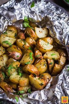 cooked potatoes in foil with parsley on top