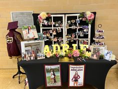 a table with pictures and flowers on it in front of a sign that says love