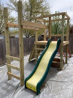 a playground with a slide and climbing frame