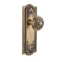 an ornate door handle with a decorative design on the front and side panel is shown