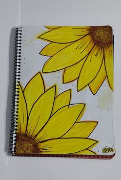 a notebook with sunflowers painted on it