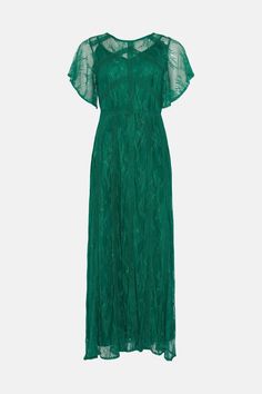 a green dress with sheer sleeves and pleaing on the shoulders, in front of a white background