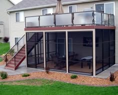 a patio with an umbrella over it next to a house