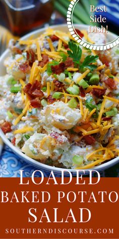 loaded baked potato salad with bacon, cheese and green onions in a white bowl on a blue plate