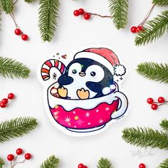 a penguin in a cup with candy canes and christmas decorations on the side, surrounded by pine branches