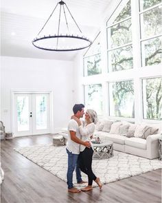 a man and woman are dancing in the living room