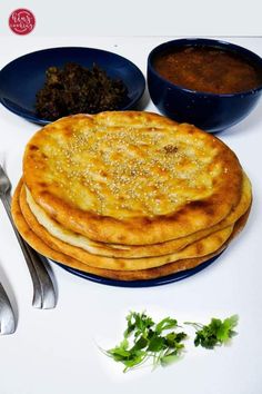 some food is sitting on a plate with spoons and silverware next to it