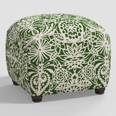 a green and white ottoman with an intricate design