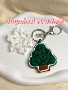 a crocheted christmas tree keychain with a snowflake on it