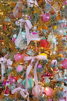 a christmas tree decorated with ornaments and ribbons