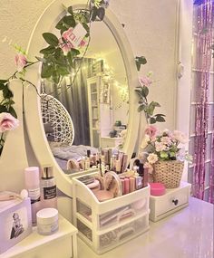 a white vanity with flowers and cosmetics on it