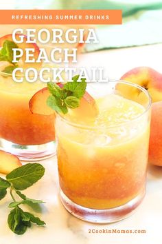 two glasses filled with peach cocktail sitting on top of a table