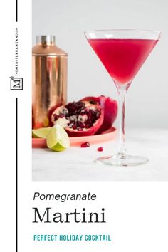 a pink cocktail with pomegranate on the rim