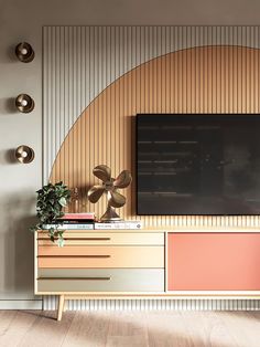 a living room with a large television mounted on the wall and wooden paneled walls