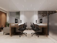 an office with two desks and chairs in front of a glass wall that leads up to the second floor