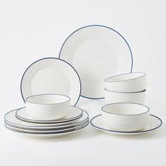 a white and blue dinner set with plates