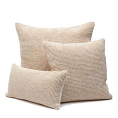 two beige pillows sitting on top of each other