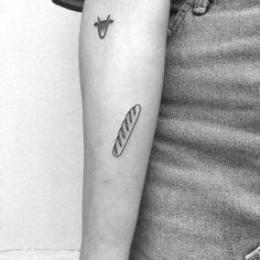 a black and white photo of a woman's arm with a tattoo on it