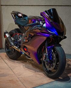 a shiny motorcycle parked in front of a building