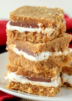 three dessert bars stacked on top of each other with marshmallows and chocolate