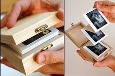 two photos are being held in an open wooden box and another is holding the same photo