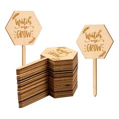 a stack of wooden signs sitting next to each other on top of a white background