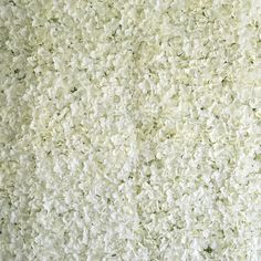 the wall is covered in white flowers