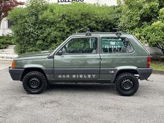 an suv parked in a parking lot next to bushes and shrubbery with the word liberty written on it