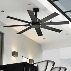 a ceiling fan with five blades is hanging from the ceiling in an empty room next to chairs