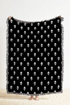 a black and white blanket with skulls on it