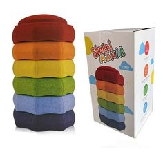 a stack of colorful towels sitting next to a box