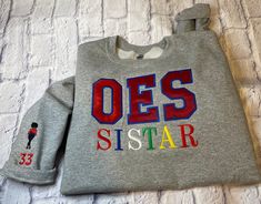 This is an embroidered OES SISTAR sweatshirt or crewneck that is soft and comfortable. This sweatshirt is neatly stitched with high quality thread. The sweatshirt is listed in gray if you need another color please message me. The sweatshirt is unisex and the brand is Gildan Heavy Blend. Please be sure to add your chapter number for the sleeve in the personalization box. If you don't want anything on the sleeve please add that in personalization box.  There are no refunds or exchanges due to the item is personalized. Please feel free to message me anytime. Embroidered Shirts, Embroidery Monogram, Divine Light, New Journey, Embroidered Shirt, Sweat Shirt, Short Hair Styles