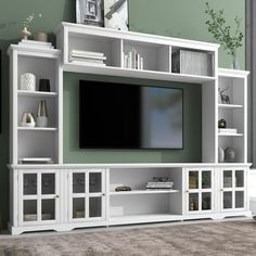 a white entertainment center with glass doors and shelves