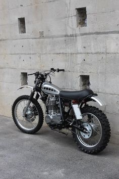 a dirt bike parked in front of a concrete wall