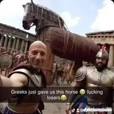 two men dressed as roman soldiers and one is pointing at the camera while another man stands in front of them