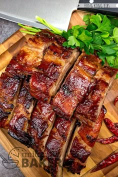 sliced up meat sitting on top of a wooden cutting board