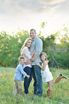 a family posing for a photo in the grass