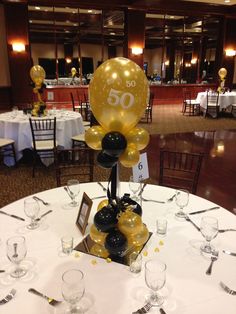 a white table topped with balloons and wine glasses