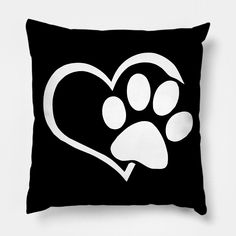 a black and white pillow with a heart shaped paw print on the front that has a dog's paw in it