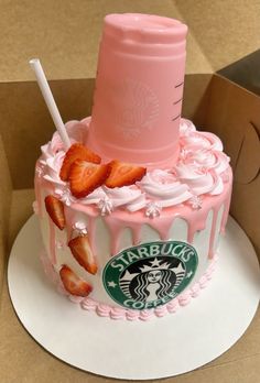 a starbucks cup cake with strawberries on top