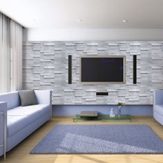 a living room with blue couches and a flat screen tv mounted on the wall