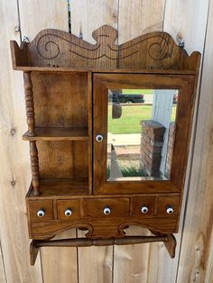 a wooden shelf with a mirror on top of it