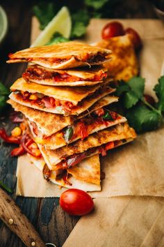 a stack of quesadillas sitting on top of a wooden cutting board