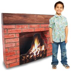 a young boy standing next to a fake fireplace with flames on the front and sides