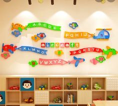 the children's room is decorated with colorful wooden letters and vehicles, along with toys